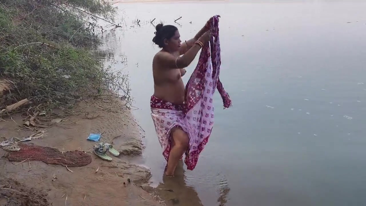 Indian village wife bathing in the river in outdoor area