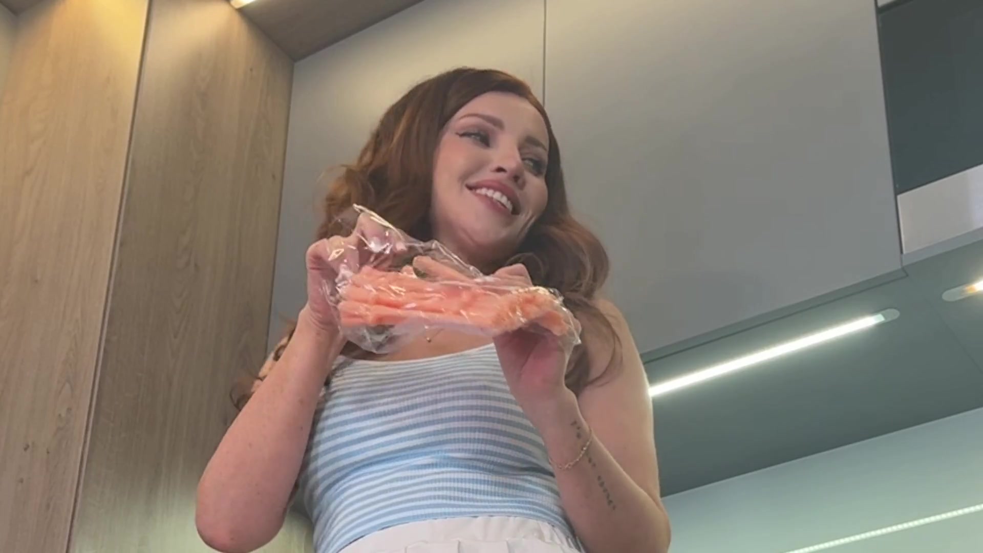 Wonderfully beautiful amazing girl in the kitchen shows her white panties under her mini flirty skirt